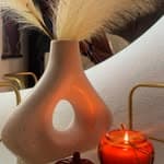 Decorative vase with dried pampas grass and a candle